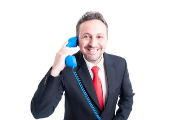 Naklejka premium Smiling sales man answering phone