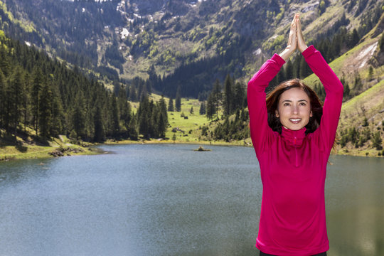Woman in Namaste pose in nature
