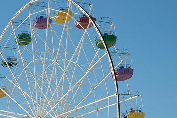 Ferris wheel over blue sky