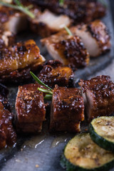 Close view on grilled crispy pork belly with sticky glaze