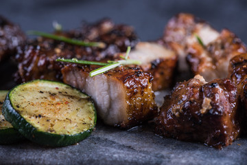 Close view on grilled crispy pork belly with sticky glaze