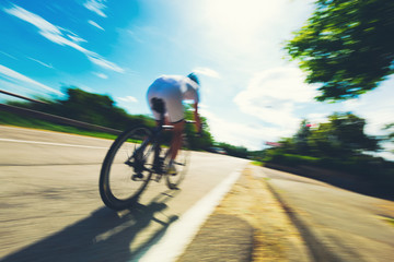 Cyclist speeding during a competition in summer