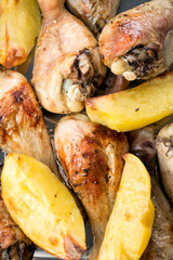 Roasted chicken legs with potatoes.