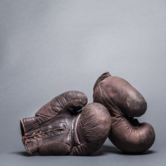 vintage boxing gloves on a gray background