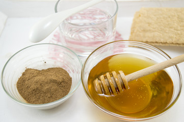 Honey and cinnamon in glass vessels on a table