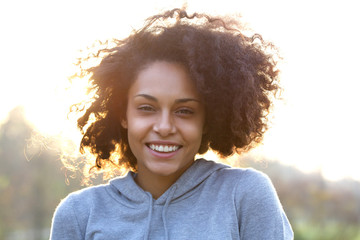 Happy smiling young woman with curly hair