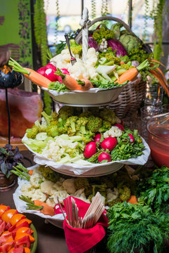 Vegetable bar on restaurant's table/Raw vegetables on multilevel trays in vegetable bar at restaurant table