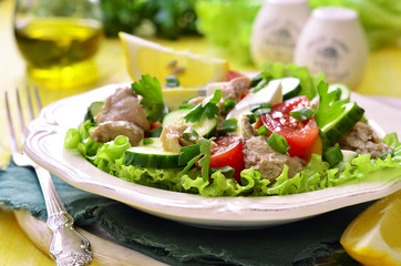 Vegetable salad with eggs and cod liver.