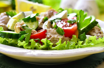 Vegetable salad with eggs and cod liver.