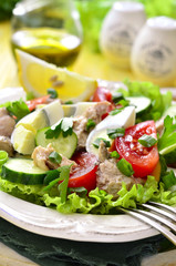 Vegetable salad with eggs and cod liver.