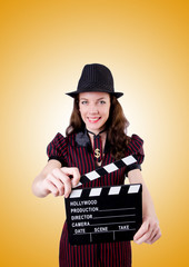 Woman gangster with movie board on white