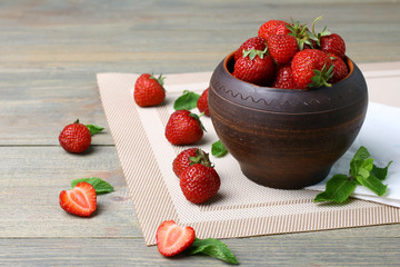 Fresh strawberries in a bowl  on a wooden background