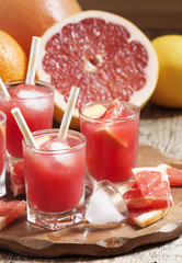 Pink grapefruit drink with pulp, selective focus