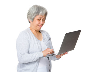 Retired woman use of laptop computer