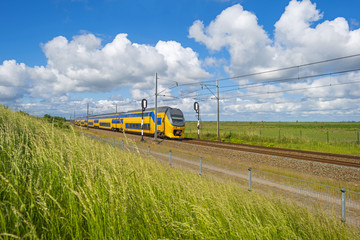 Electric train driving through nature in spring 