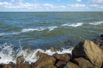 Rocks along the coast of a lake in spring