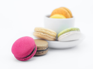 Colorful macarons with white cup and plate