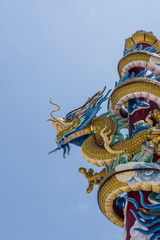 Chinese new year, Dragon statue on pole with blue sky. d
