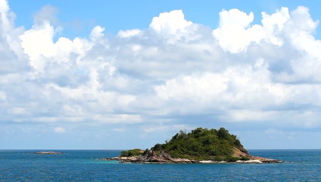 beautiful deserted island in the tropical sea with big cloud at summer time