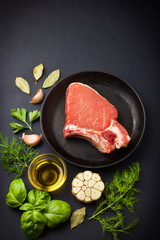 Fresh raw pork chops with spices and herbs