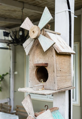 wooden bird house hanging with human house