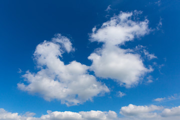 Fototapeta na wymiar Fluffy white clouds in beautiful blue sky in spring