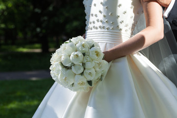 Beautiful wedding bouquet in hands of the bride