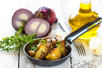     Delicious baked young potatoes on a wooden background 