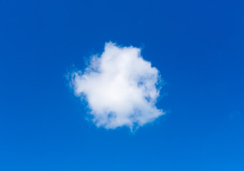 Fototapeta na wymiar Single white cloud like circle against beautiful blue sky