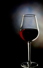 Glass of red wine on dark background
