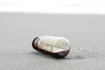 Coffe Bottle abandoned on the beach