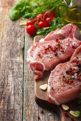 Fresh raw pork chops with spices and herbs