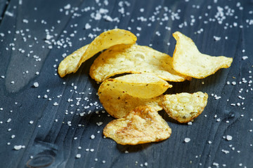 Potato chips and sprinkled salt, selective focus