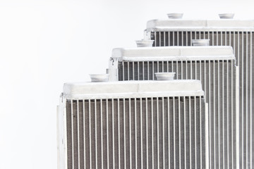 Obraz premium three new automotive radiator stove on a gray background