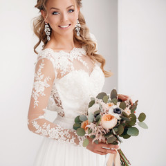 Young attractive bride with a wedding bouquet
