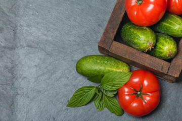 Cucumbers and Tomatoes in wooden box