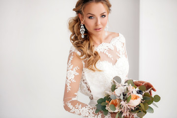 Young attractive bride with a wedding bouquet