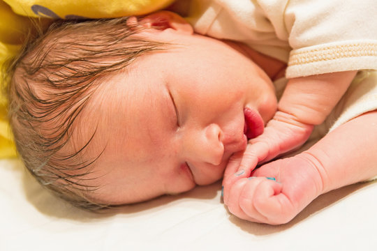 photo of a sleeping newborn baby closeup