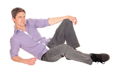 Young man sitting on floor.
