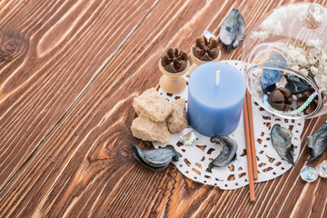 spa stuff on wooden background: candle, aroma