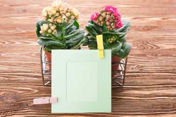 card and flowers on a wooden background