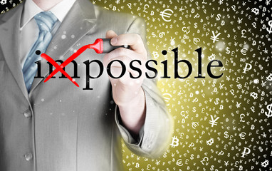 Businessman Hand turning the word Impossible into Possible with