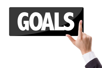 Businessman pressing button with the text: Goals