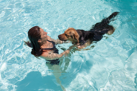 Woman Swimming With Dog