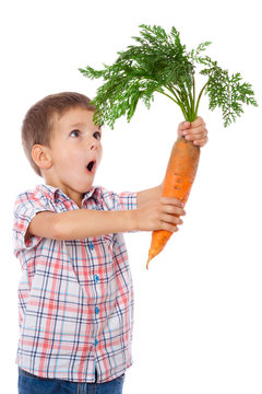Amazed boy with big carrot