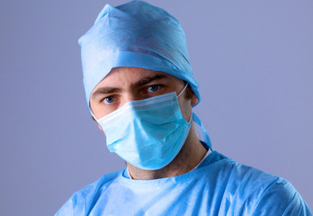 Male surgeon in mask looking at camera