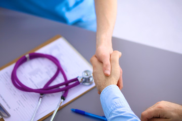 Doctor shakes hands with a patient 