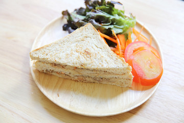 tuna sandwich on wood background