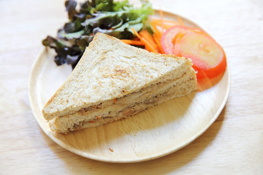 tuna sandwich on wood background