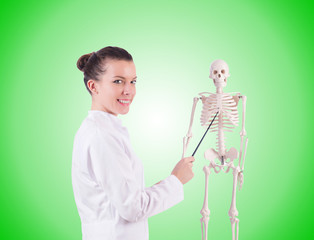 Doctor with skeleton on white